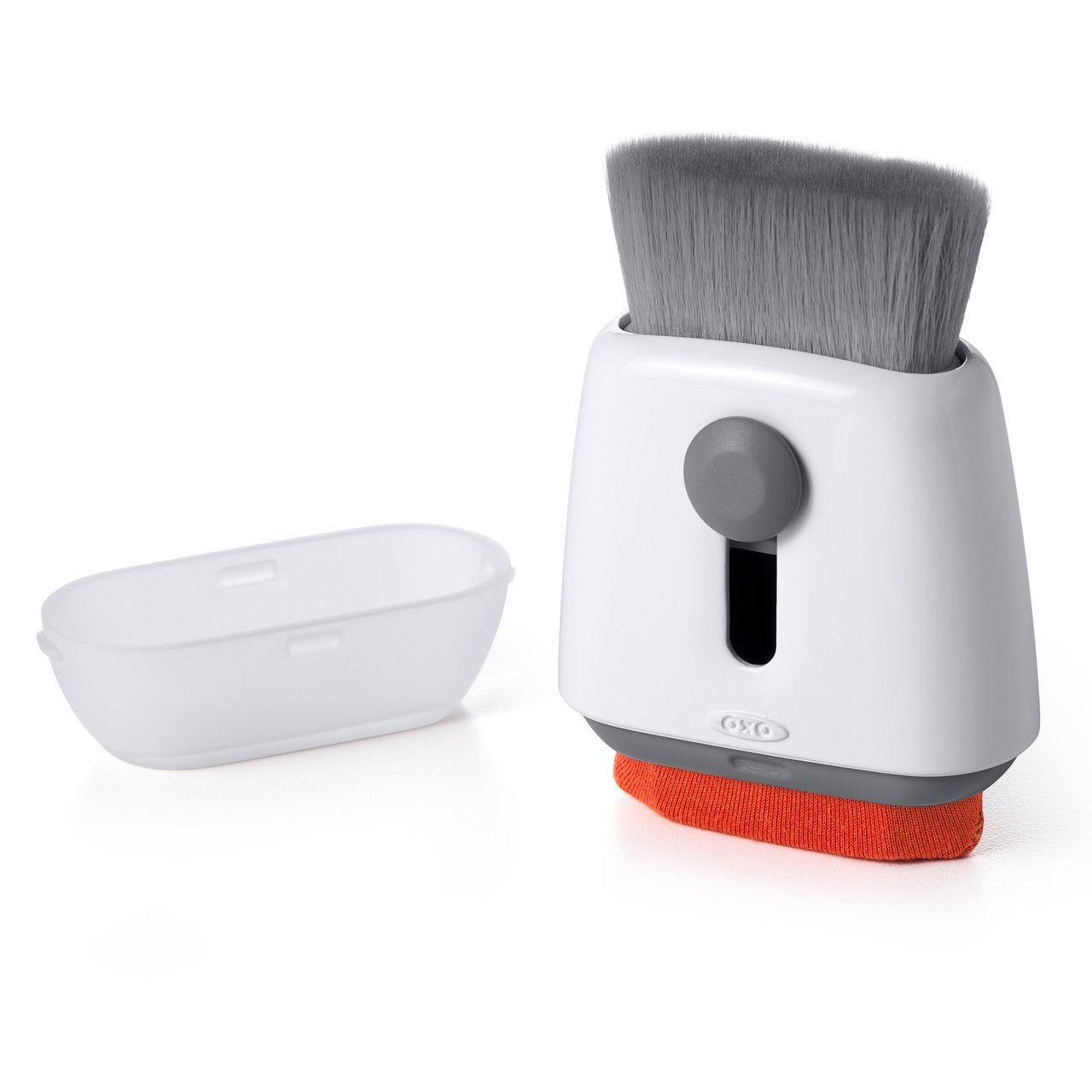 OXO Sweep & Swipe Laptop Cleaner with its brush extended and storage cap beside it